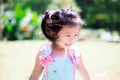 Ã Â¹â¡Happy cute girl wearing mint green shirt smile sweet. Children walk in the garden on green lawn. Summertime or spring.